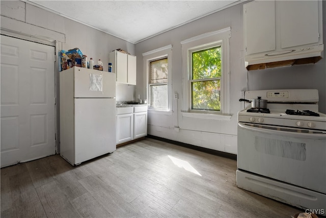 kitchen with light wood-type flooring, white cabinetry, and white appliances