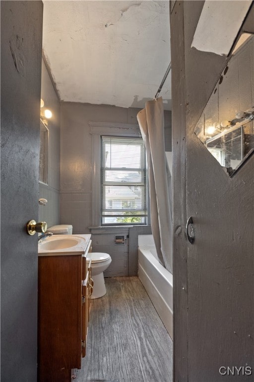 full bathroom with vanity, shower / tub combo with curtain, and toilet