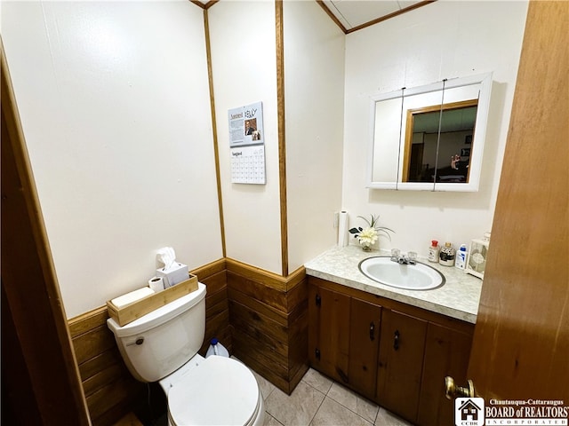 bathroom with vanity, toilet, and tile patterned flooring