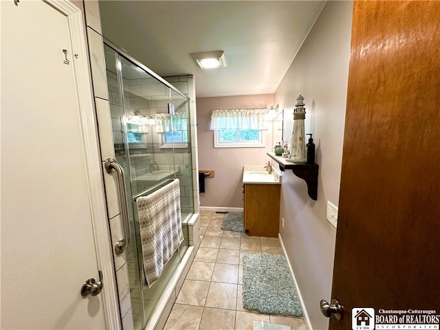 bathroom featuring vanity, tile patterned flooring, and a shower with door