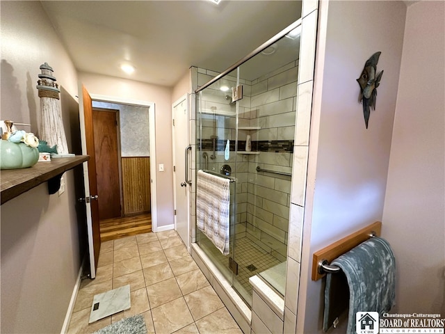 bathroom featuring tile patterned floors and a shower with shower door