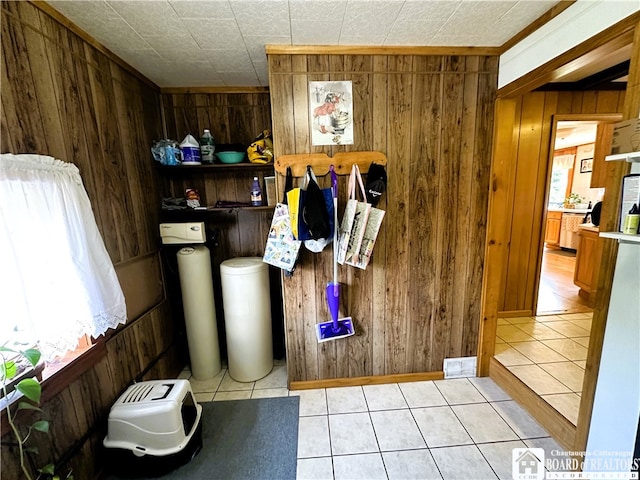 interior space with wooden walls and tile patterned flooring