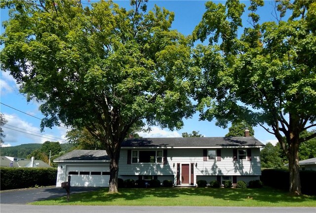 view of front of house with a garage and a front yard