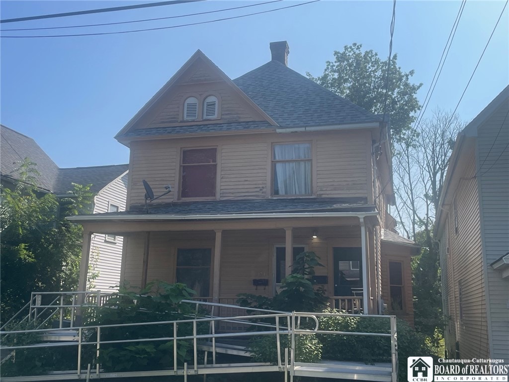 view of front of house with covered porch and roof with shingles