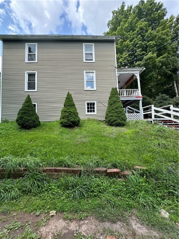 view of property exterior with a lawn