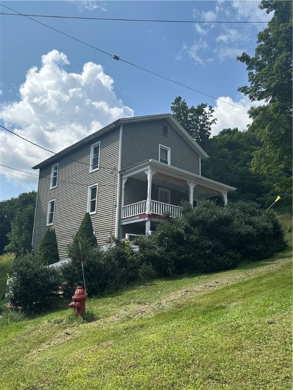 view of property exterior with a yard