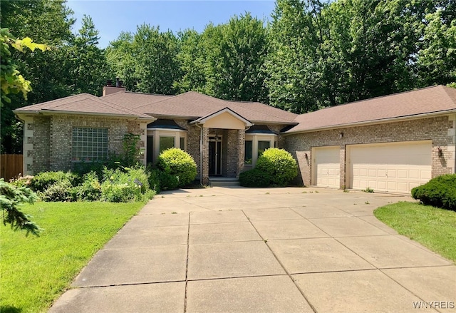 view of front facade with a garage, brick siding, concrete driveway, a front lawn, and a chimney