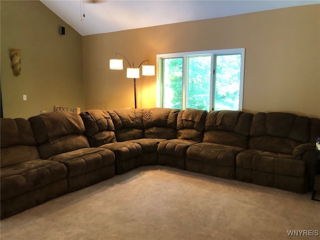 living area with light carpet and vaulted ceiling