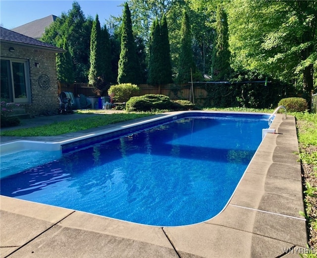 view of swimming pool featuring fence and a fenced in pool