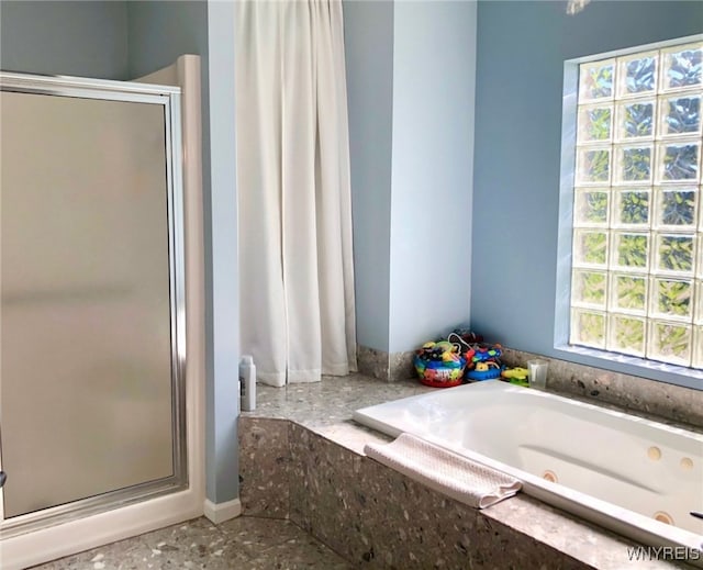 full bath featuring a tub with jets and a shower stall