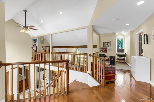 hall featuring vaulted ceiling and hardwood / wood-style flooring