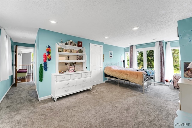 bedroom featuring a textured ceiling and carpet flooring