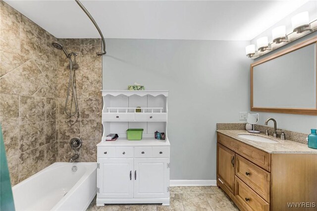 bathroom with vanity, tiled shower / bath, and tile patterned flooring