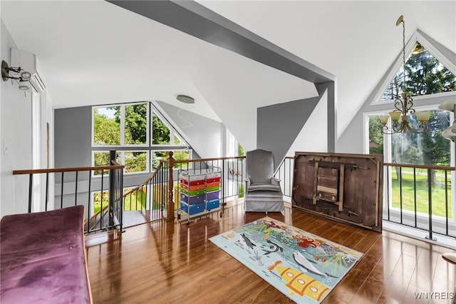 sitting room with hardwood / wood-style flooring and a chandelier