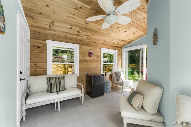 sunroom featuring lofted ceiling, ceiling fan, a healthy amount of sunlight, and wooden ceiling