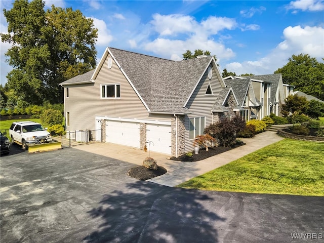 view of side of home featuring a lawn and a garage