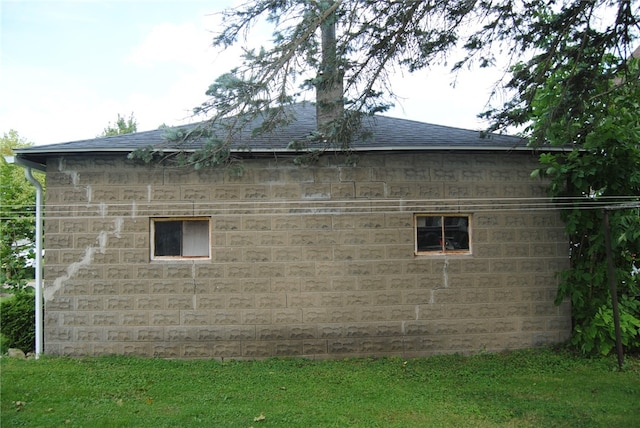 view of side of home with a lawn