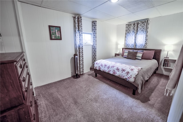 bedroom with carpet flooring and a drop ceiling