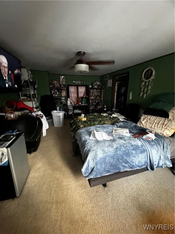 carpeted bedroom featuring ceiling fan