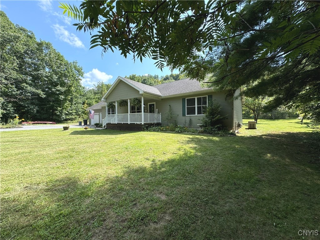 view of front of home with a porch and a front lawn