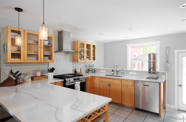 kitchen with tasteful backsplash, decorative light fixtures, sink, wall chimney exhaust hood, and appliances with stainless steel finishes