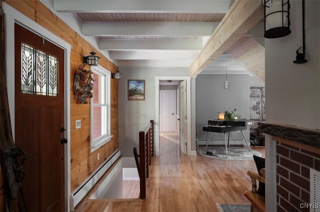 entrance foyer featuring light wood-type flooring, beamed ceiling, and a baseboard heating unit