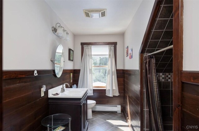 bathroom with vanity, walk in shower, toilet, tile patterned floors, and a baseboard heating unit