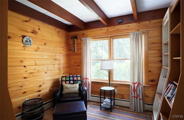 living area with a baseboard heating unit and beam ceiling