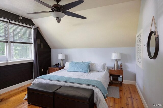 bedroom featuring lofted ceiling, light hardwood / wood-style flooring, and ceiling fan