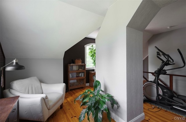 living area featuring vaulted ceiling and hardwood / wood-style floors