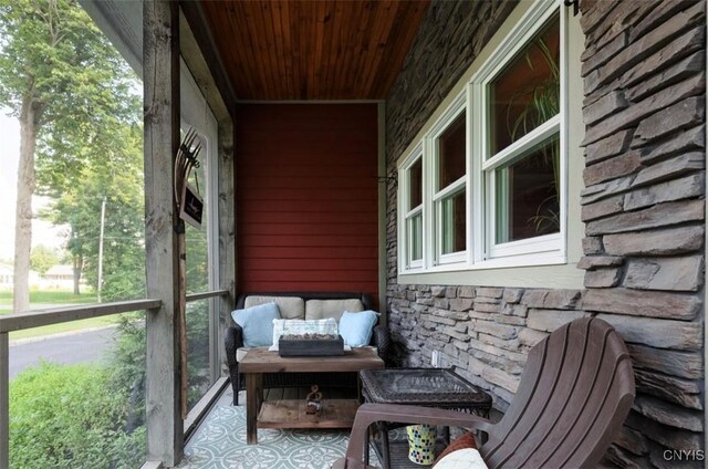 sunroom / solarium featuring wood ceiling