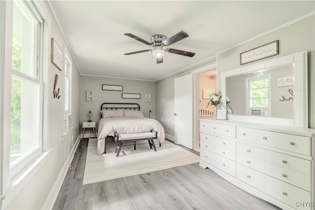 bedroom with ceiling fan, light hardwood / wood-style floors, and ornamental molding