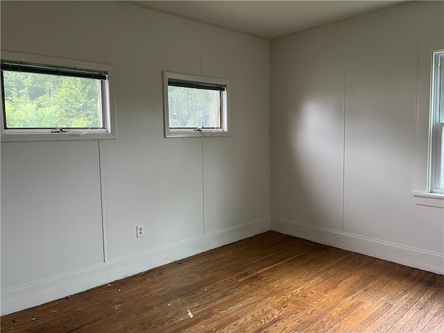 empty room with hardwood / wood-style floors