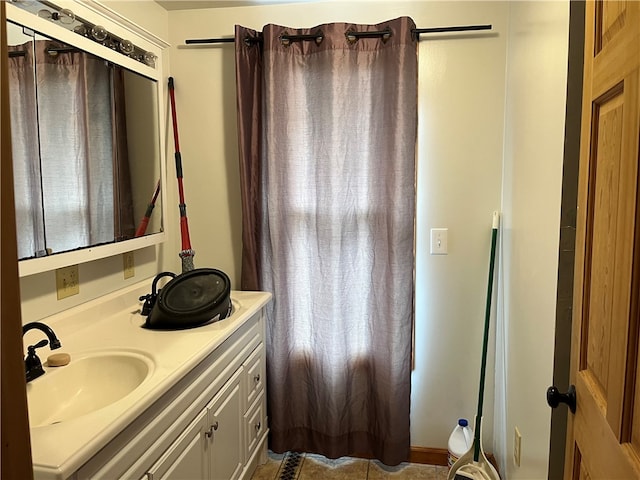 bathroom with tile patterned floors and vanity