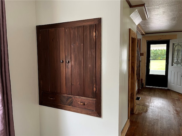 entrance foyer featuring a textured ceiling and wood-type flooring