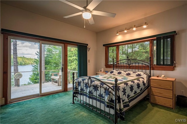 bedroom featuring access to outside, dark carpet, and a ceiling fan