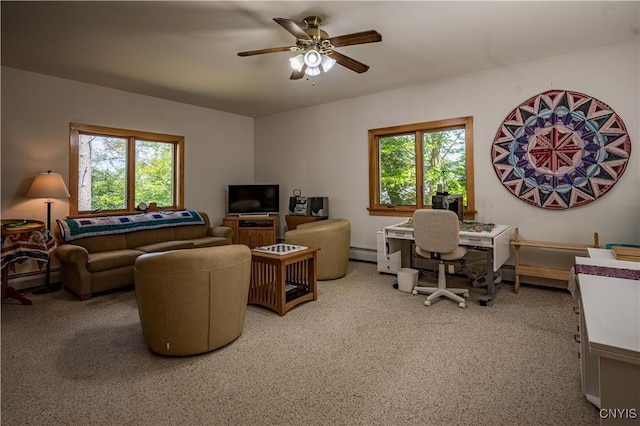 office space featuring carpet floors, a baseboard radiator, a wealth of natural light, and a ceiling fan