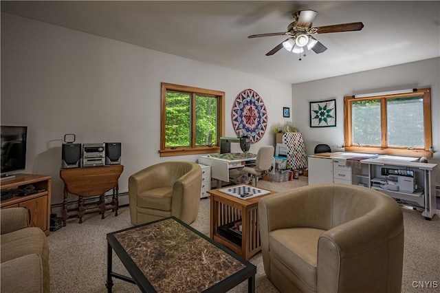 carpeted living room with a baseboard heating unit and ceiling fan