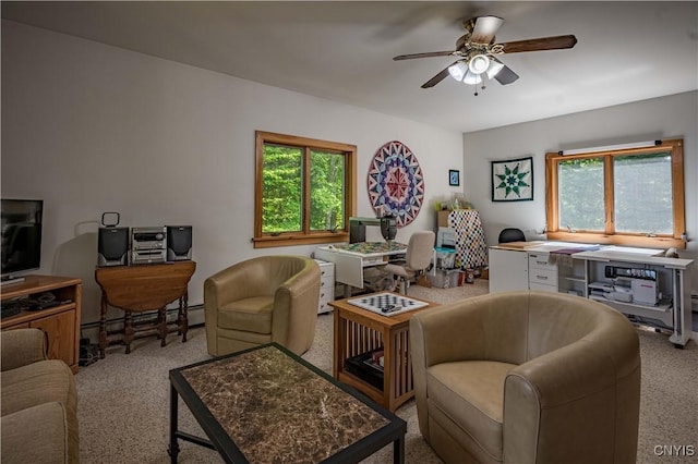 living area with a baseboard heating unit and a ceiling fan