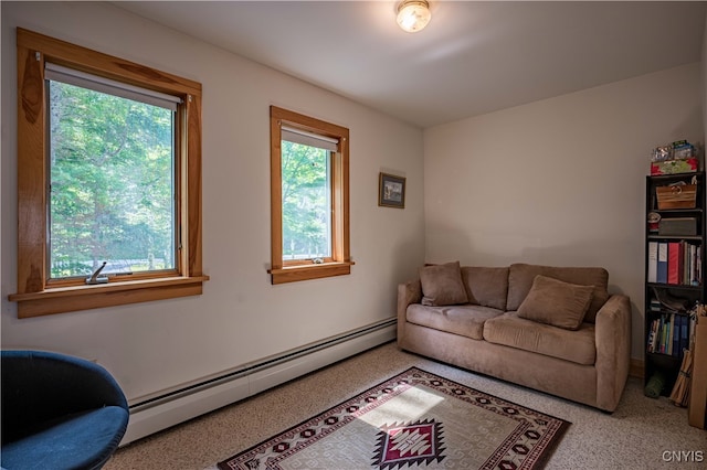 living room featuring a baseboard heating unit and carpet floors