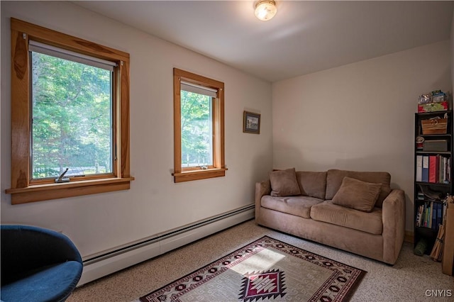 living area featuring baseboard heating and plenty of natural light