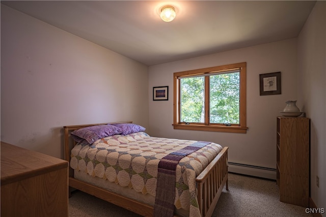 carpeted bedroom with a baseboard heating unit