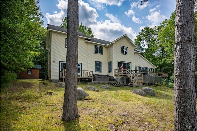 rear view of property with a yard and a deck