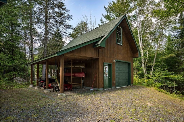 view of side of home with an outdoor structure and a garage