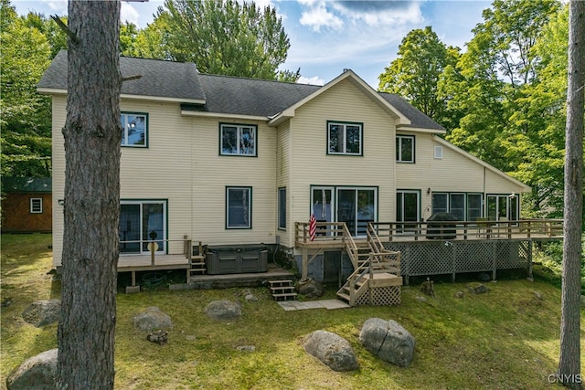 back of house featuring a yard and a wooden deck