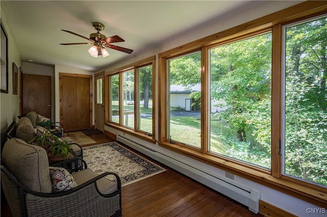 unfurnished sunroom with baseboard heating, a healthy amount of sunlight, and ceiling fan