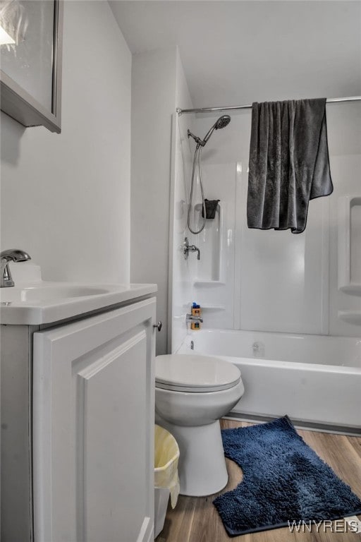 full bathroom with vanity, toilet, shower / bath combination, and hardwood / wood-style floors