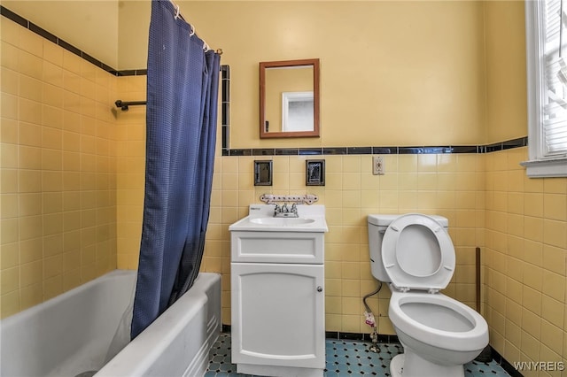 full bathroom with tile walls, toilet, tile patterned floors, and shower / bath combo with shower curtain