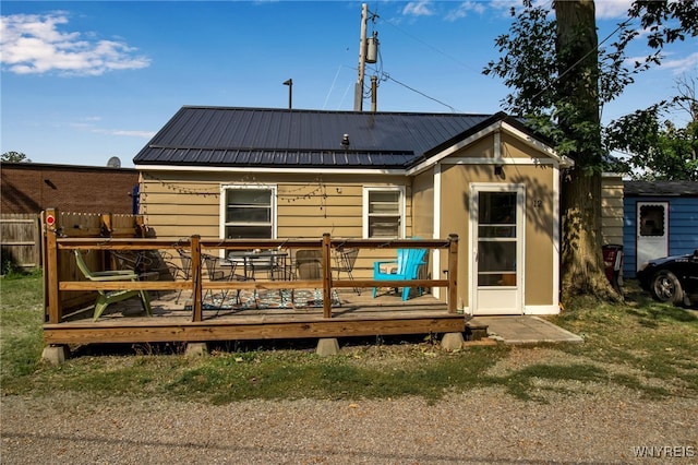 rear view of property with a wooden deck