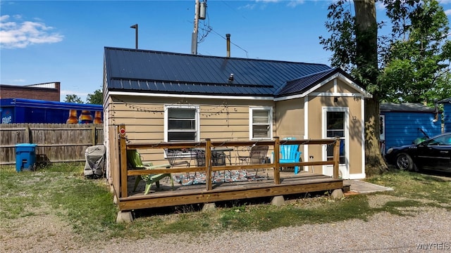 rear view of house featuring a deck